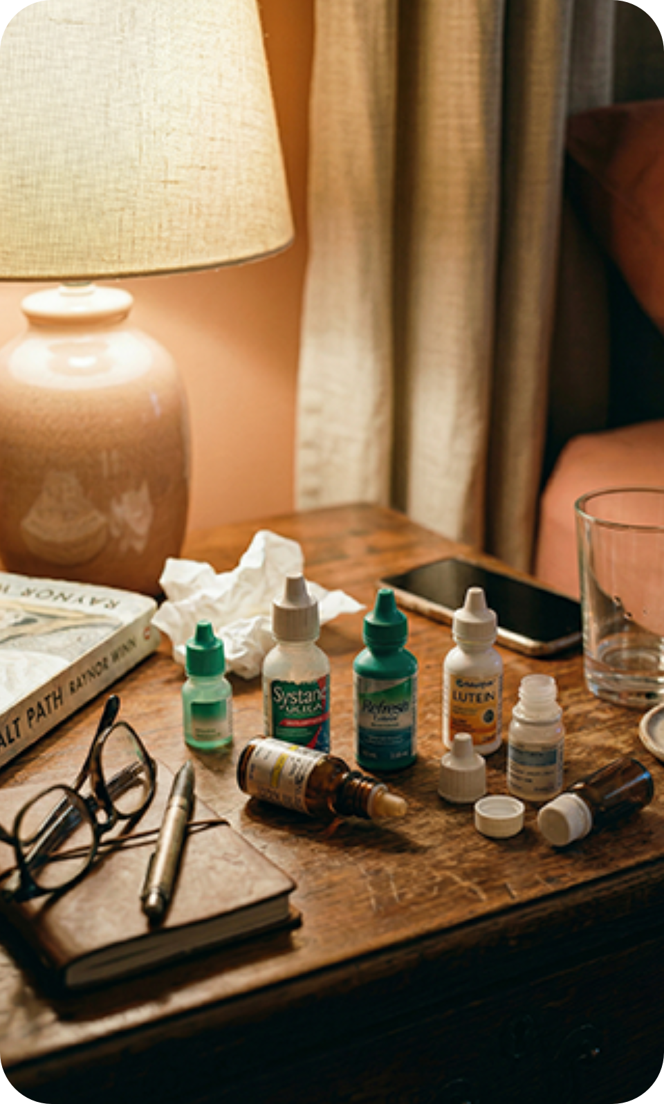 Eye drop bottles on a bedside table