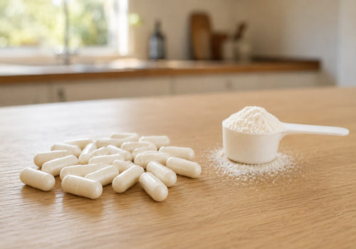 Magnesium tub open with a scoop, beside loose capsules